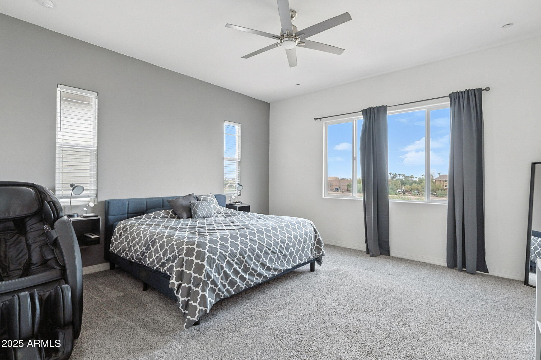 7236 West Phelps Road Peoria, AZ 85382 - Photo 38 of 53 a bedroom with a bed a dresser and a window