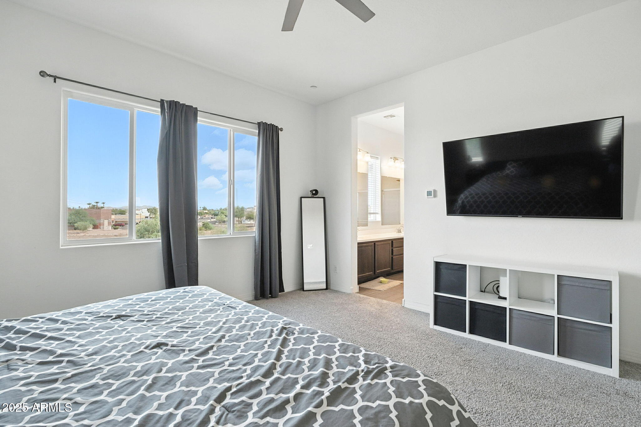 7236 West Phelps Road Peoria, AZ 85382 - Photo 41 of 53 a bedroom with a bed and a flat screen tv