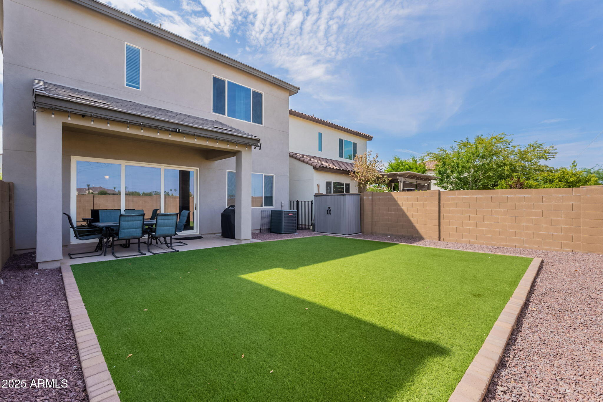 7236 West Phelps Road Peoria, AZ 85382 - Photo 46 of 53 a view of a house with a backyard porch and sitting area
