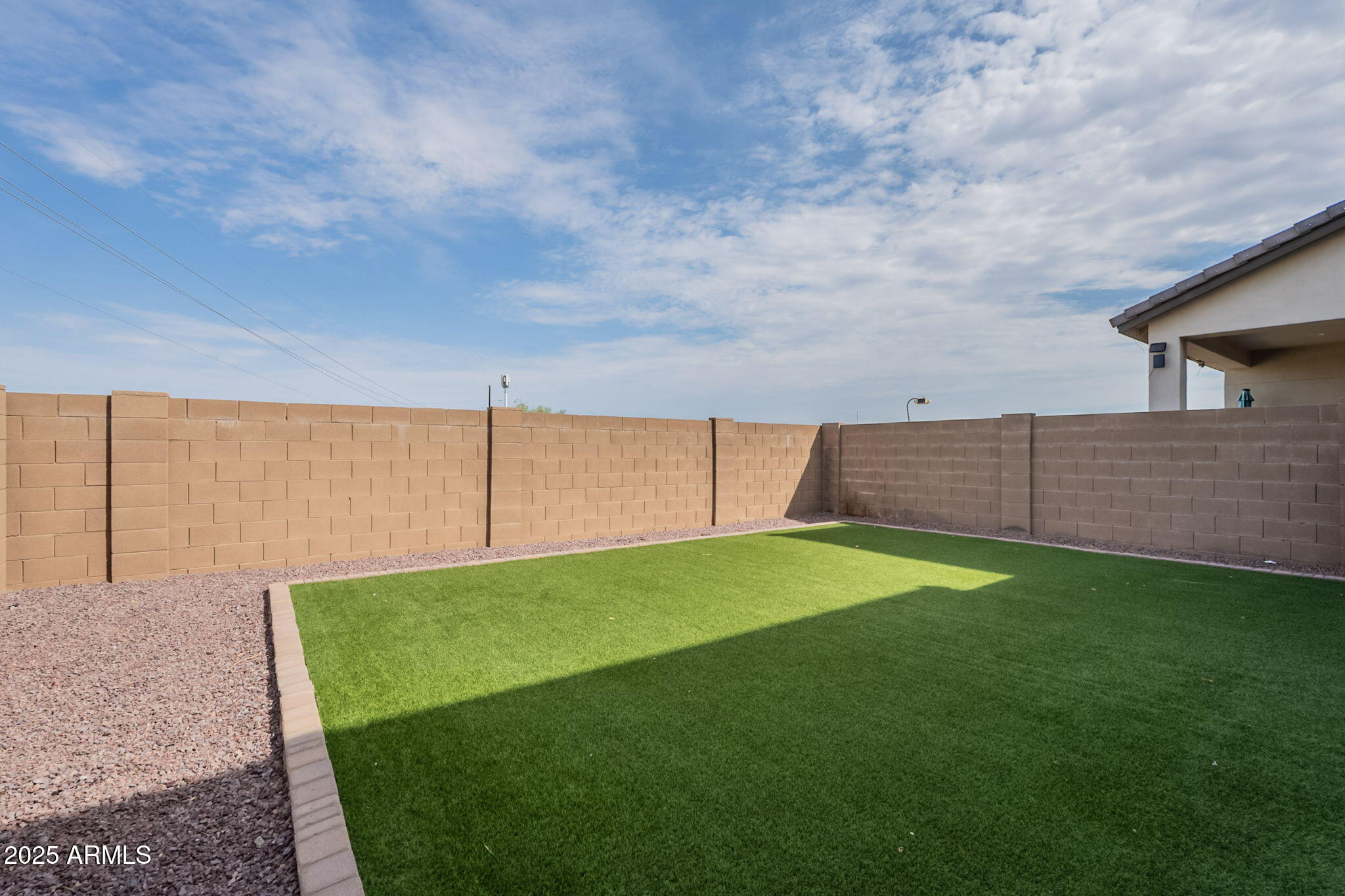 7236 West Phelps Road Peoria, AZ 85382 - Photo 49 of 53 a view of a backyard with grass