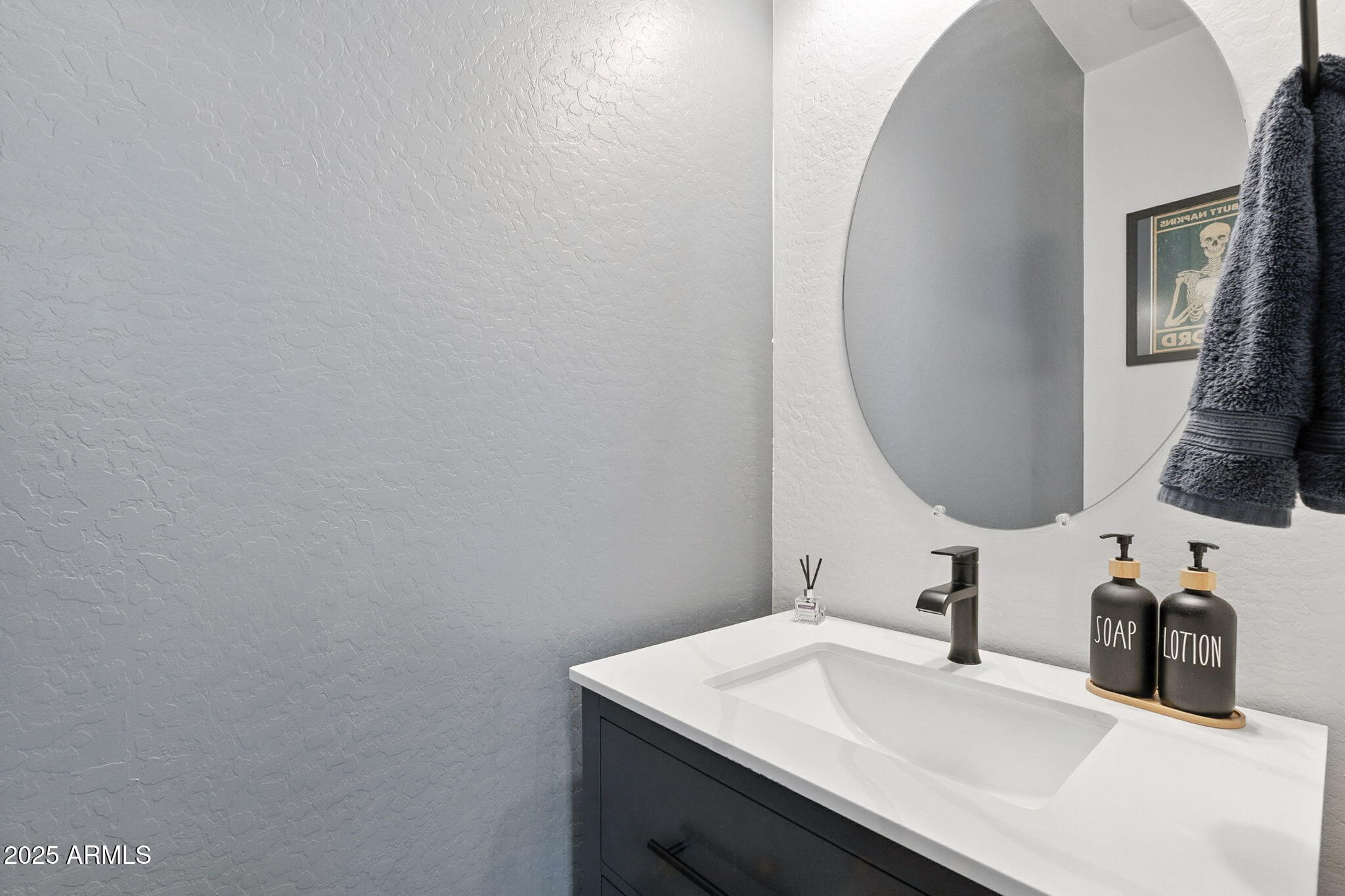 7236 West Phelps Road Peoria, AZ 85382 - Photo 6 of 53 a bathroom with a sink and a mirror