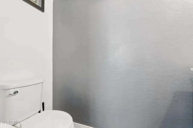 a white toilet sitting next to a shower