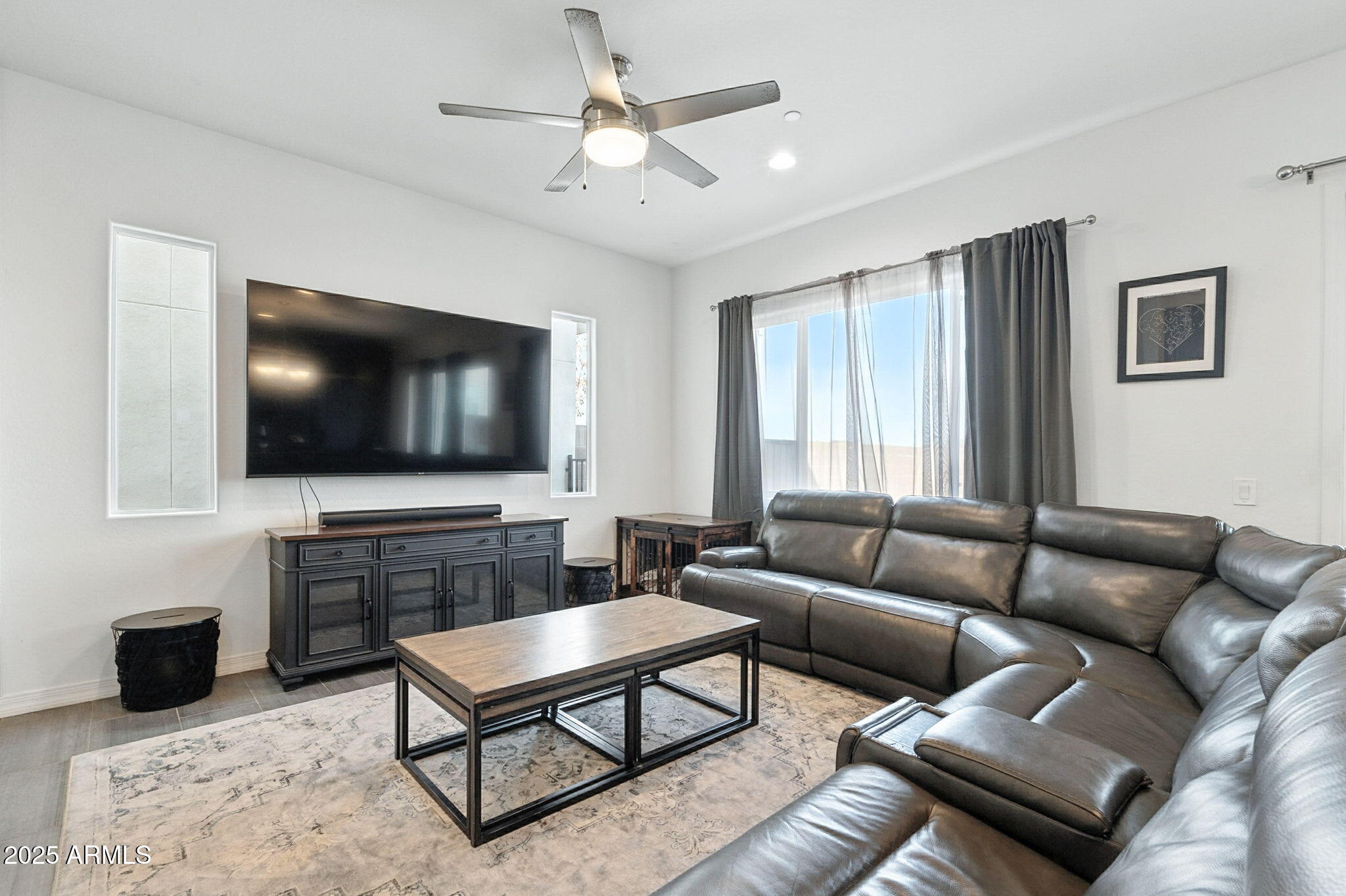 7236 West Phelps Road Peoria, AZ 85382 - Photo 8 of 53 a living room with furniture and a flat screen tv