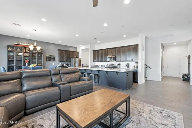 a living room kitchen with a couch and a view of kitchen
