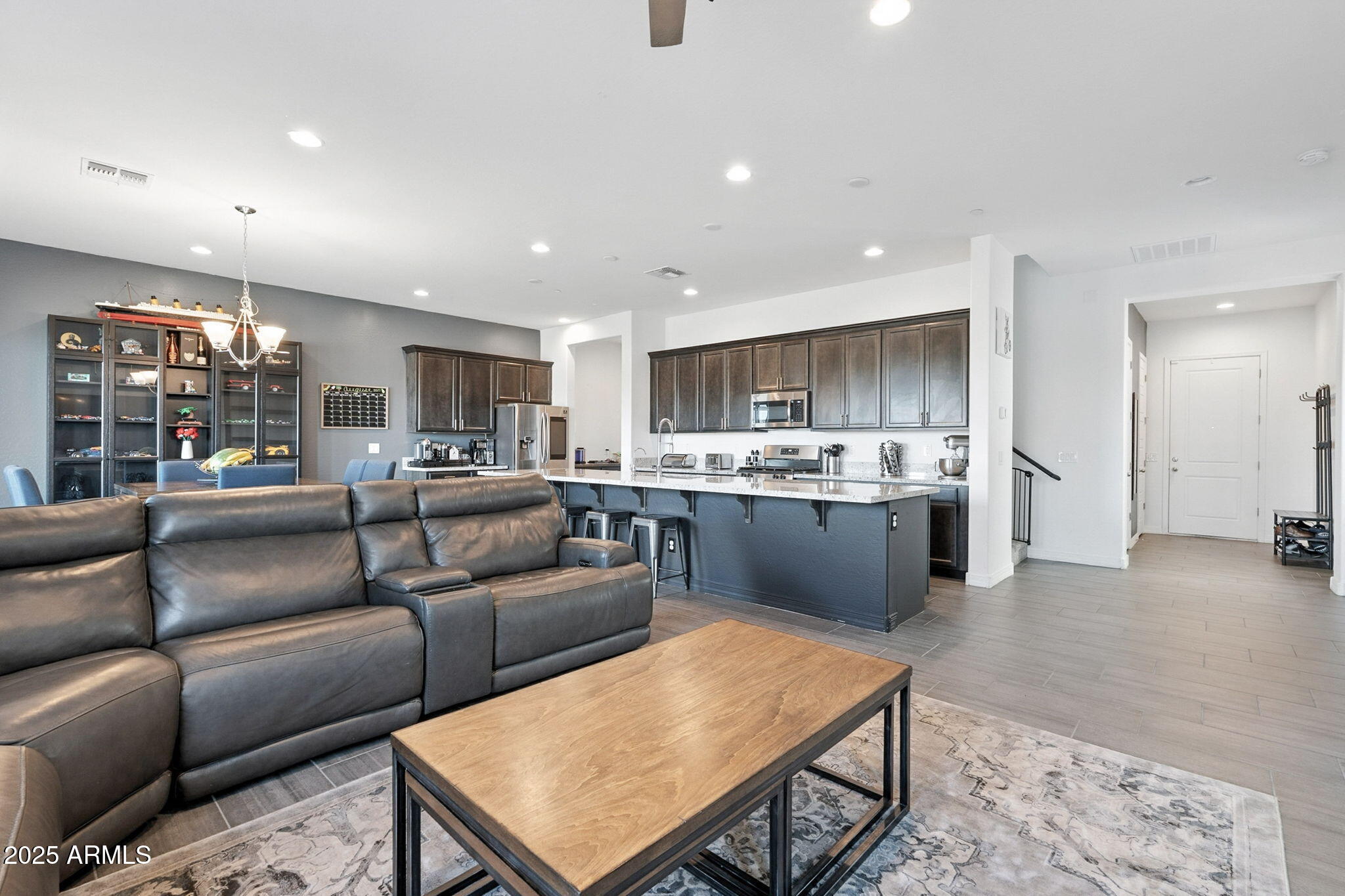 7236 West Phelps Road Peoria, AZ 85382 - Photo 10 of 53 a living room kitchen with a couch and a view of kitchen