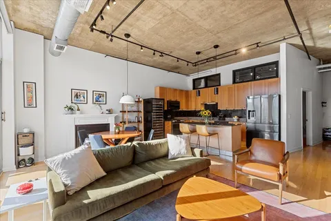 a living room with furniture and kitchen view