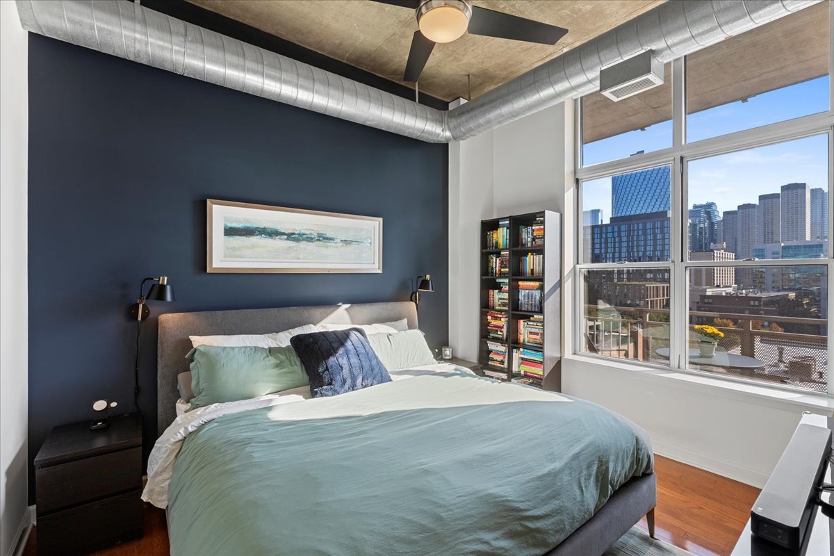 111 South Morgan Street, Unit 823 Chicago, IL 60607 - Photo 13 of 20 a bedroom with a large bed and a window