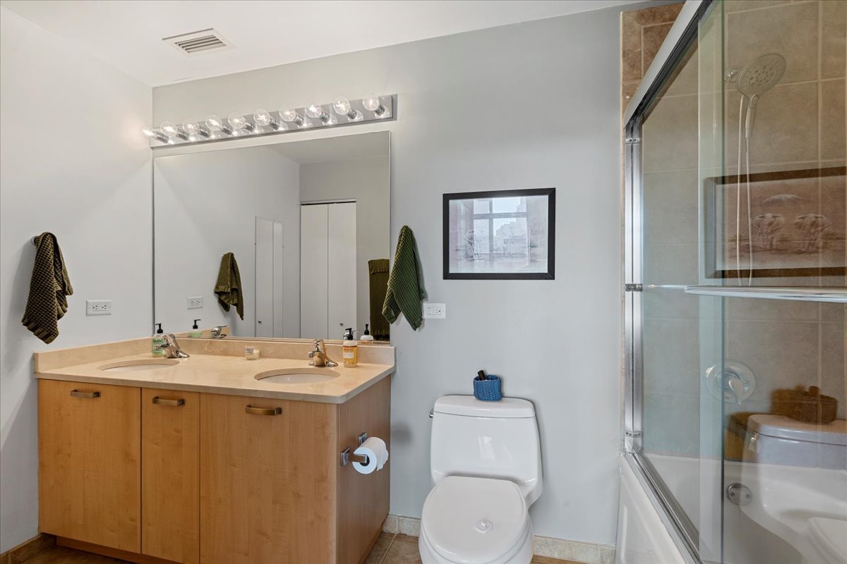 111 South Morgan Street, Unit 823 Chicago, IL 60607 - Photo 15 of 20 a bathroom with a toilet sink and mirror