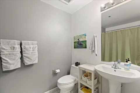 a bathroom with a sink a toilet and mirror