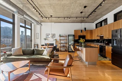 a living room with lots of furniture and kitchen view