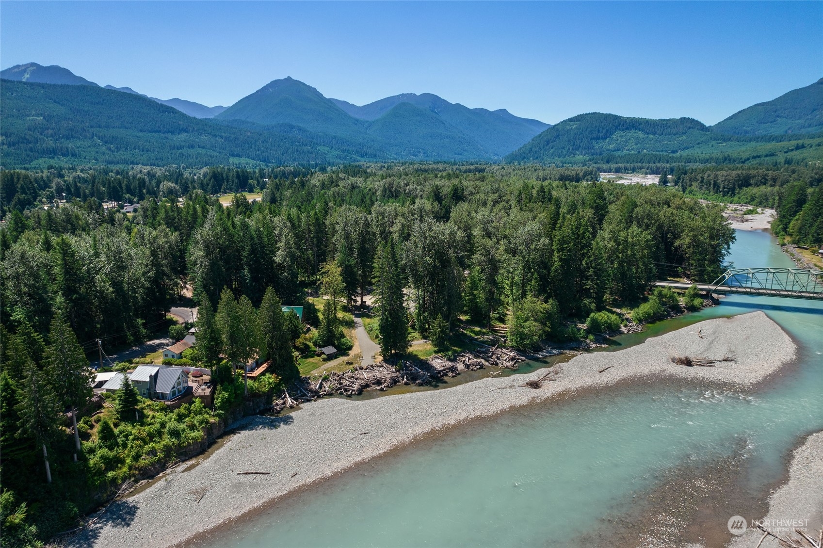 136 Bugle Lane Packwood, WA 98361 - Photo 16 of 32 a view of a lush green hillside and a building