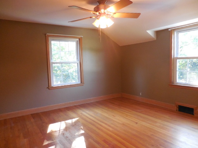 5159 Spring Creek Road Rockford, IL 61114 - Photo 16 of 25 a view of an empty room with wooden floor and a window