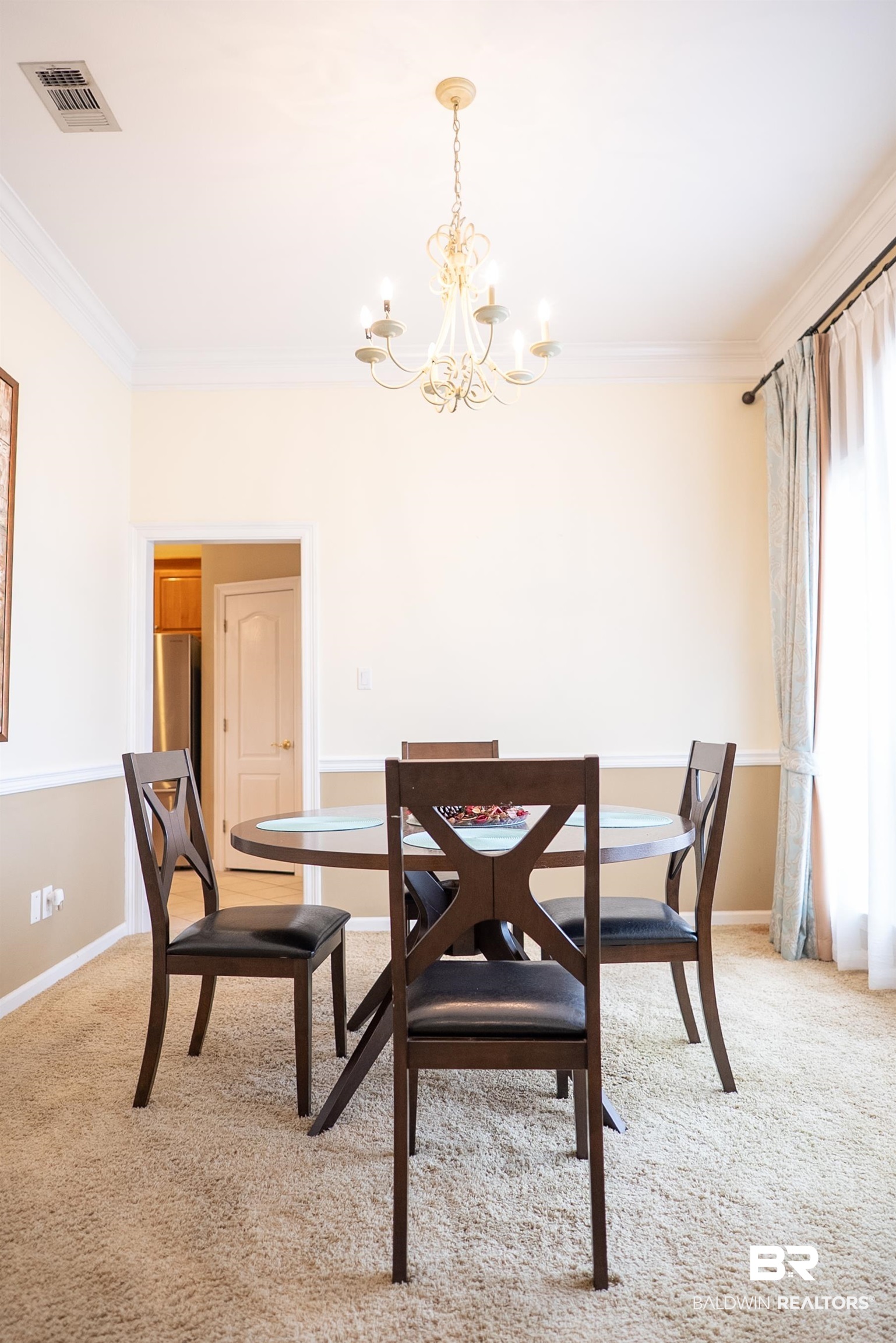 10023 Springfield Court Mobile, AL 36695 - Photo 10 of 50 Dining room with light colored carpet, crown molding, and a chandelier