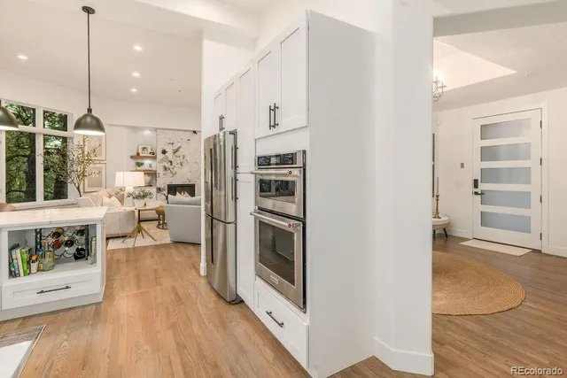 a kitchen with stainless steel appliances a refrigerator and a stove top oven