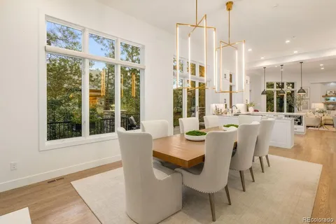 a dining room with furniture a chandelier and a rug