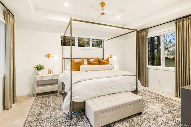 a bedroom with a large bed and a window