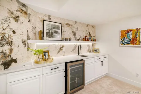 a kitchen with stainless steel appliances a sink table and chairs