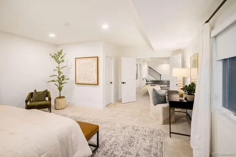 a bedroom with a bed and a painting on the wall