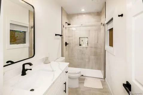 a bathroom with a sink toilet and shower