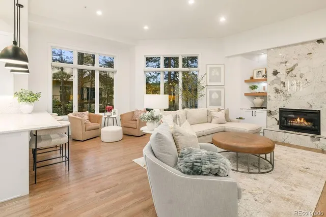 a kitchen with stainless steel appliances kitchen island granite countertop a table chairs and a sink