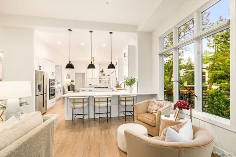 a living room with furniture fireplace and a large window