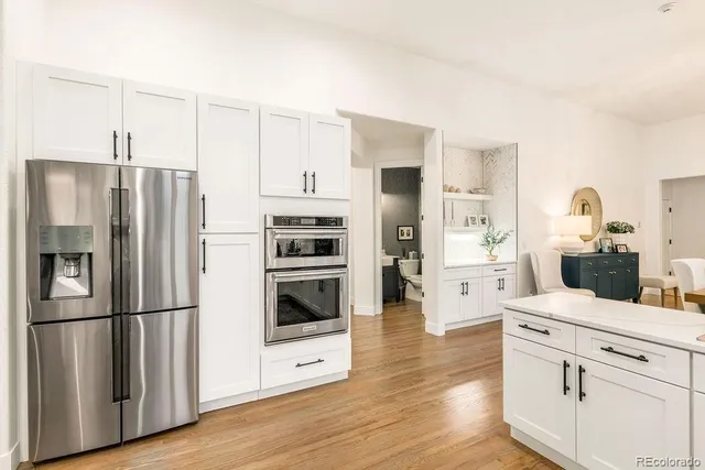 a kitchen with stainless steel appliances a refrigerator stove and cabinets