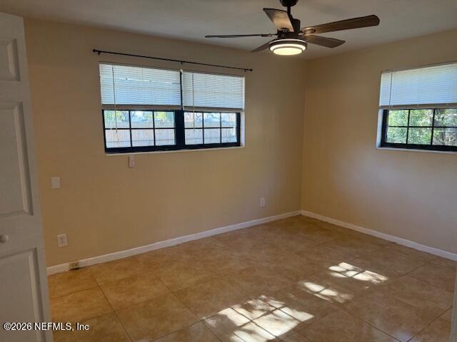 8114 Fresca Street Jacksonville, FL 32217 - Photo 16 of 29 an empty room with windows and ceiling fan