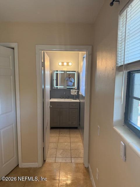 8114 Fresca Street Jacksonville, FL 32217 - Photo 18 of 29 a en suite bathroom with a sink a mirror and a bathtub