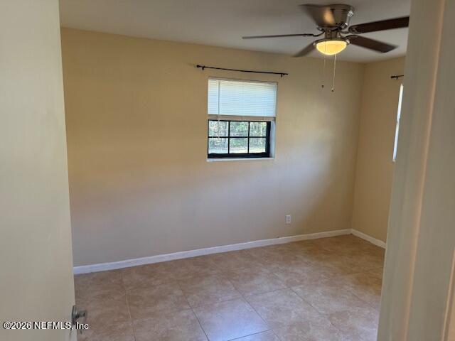 8114 Fresca Street Jacksonville, FL 32217 - Photo 20 of 29 an empty room with a window and a fan