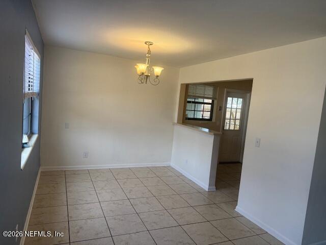 8114 Fresca Street Jacksonville, FL 32217 - Photo 5 of 29 an empty room with wooden floor and mirror