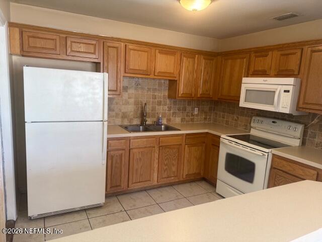 8114 Fresca Street Jacksonville, FL 32217 - Photo 8 of 29 a kitchen with stainless steel appliances a refrigerator sink and microwave
