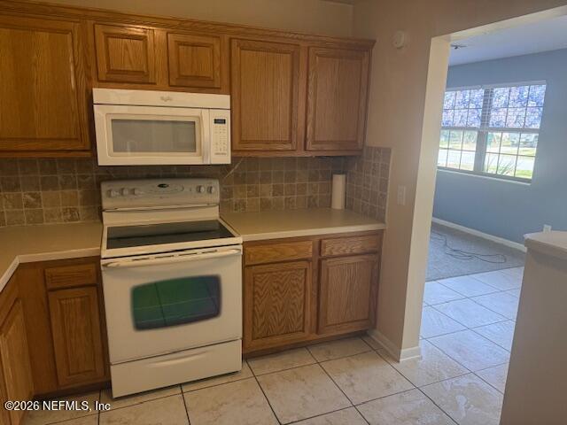 8114 Fresca Street Jacksonville, FL 32217 - Photo 9 of 29 a kitchen with white cabinets and white appliances
