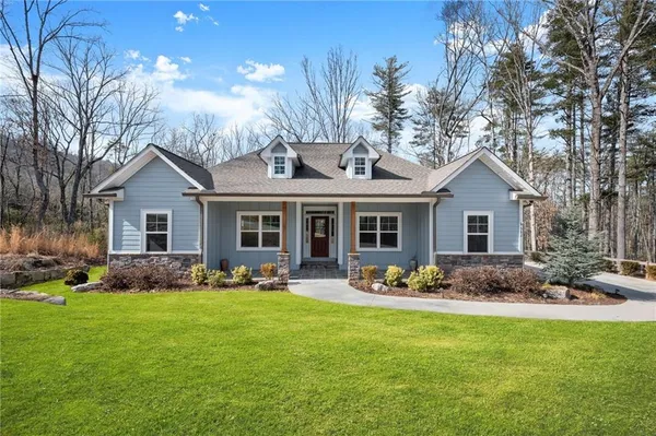 a front view of house with yard outdoor seating and green space