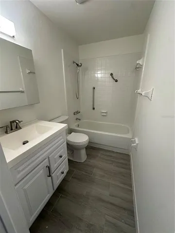a bathroom with a double vanity sink toilet a mirror and shower