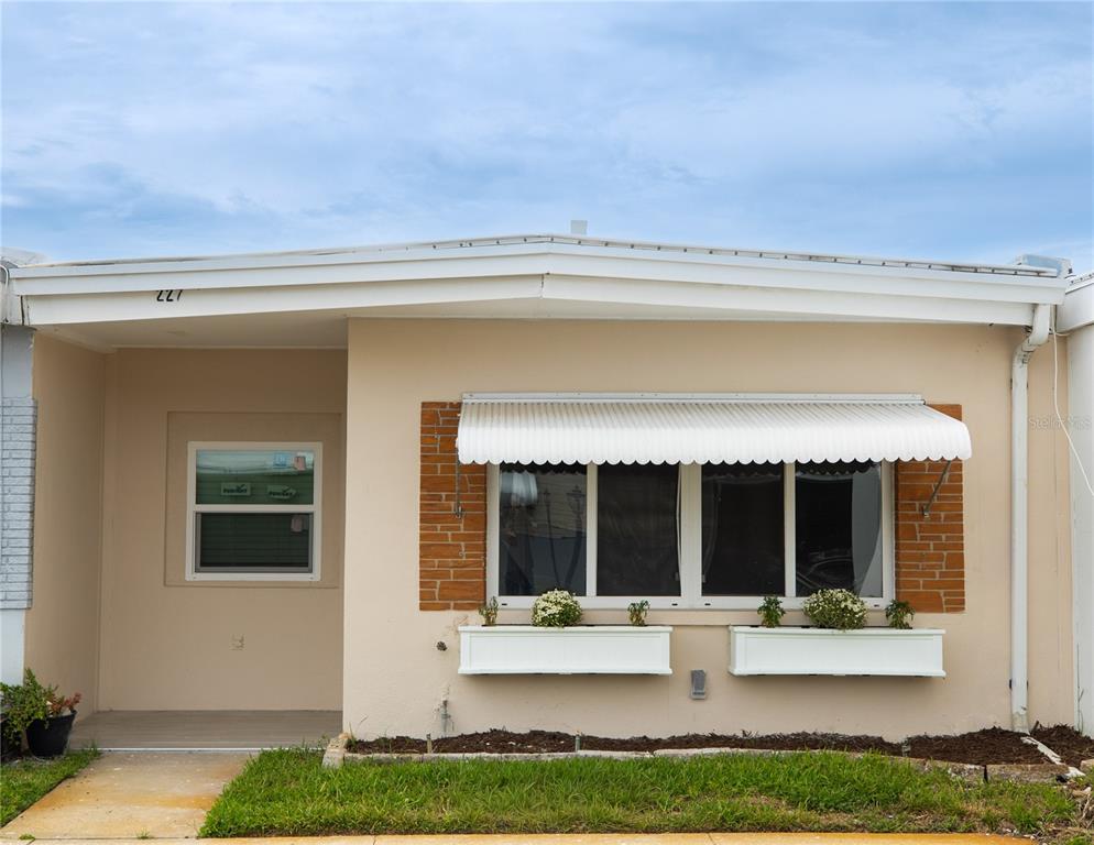 250 Rosery Road Northwest, Unit 227 Largo, FL 33770 - Photo 17 of 18 a view of house with backyard outdoor seating and mountain view