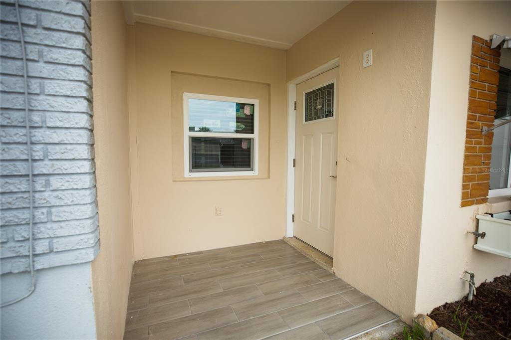 250 Rosery Road Northwest, Unit 227 Largo, FL 33770 - Photo 18 of 18 a view of a hallway with wooden floor and a bathroom