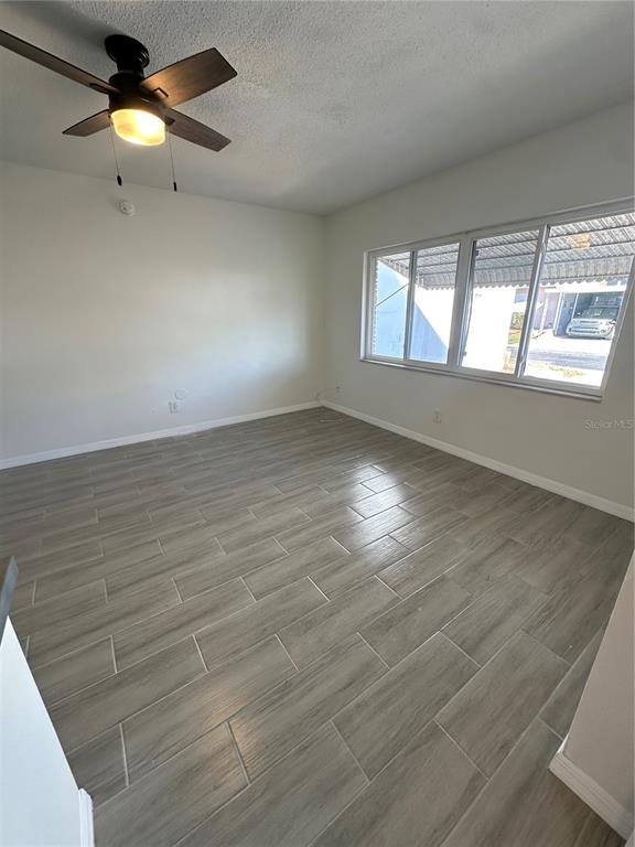 250 Rosery Road Northwest, Unit 227 Largo, FL 33770 - Photo 9 of 18 wooden floor in an empty room with a window