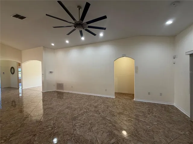 a view of a livingroom with a ceiling fan and window
