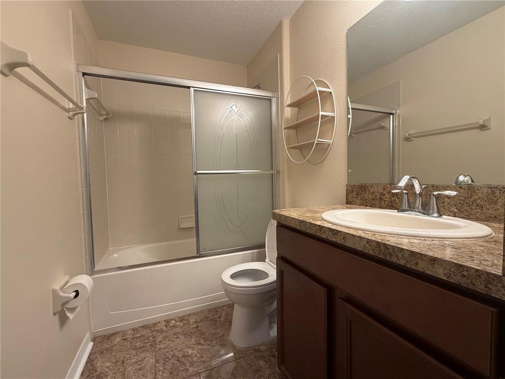 10214 Summer Azure Drive Riverview, FL 33578 - Photo 13 of 23 a bathroom with a granite countertop sink toilet and shower