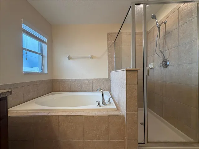 a bath tub sitting next to a shower