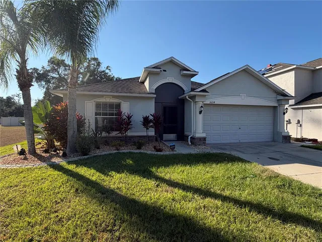 a view of a house with swimming pool and a yard