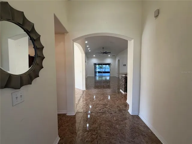a view of a hallway with wooden floor and entryway