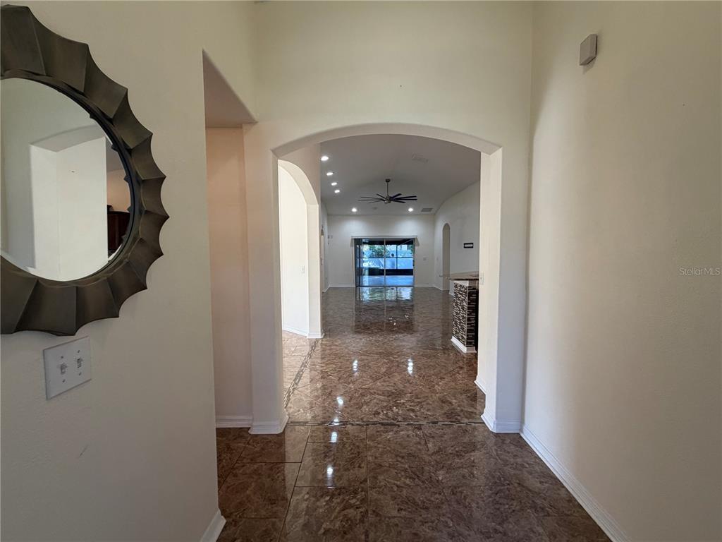 10214 Summer Azure Drive Riverview, FL 33578 - Photo 3 of 23 a view of a hallway with wooden floor and entryway