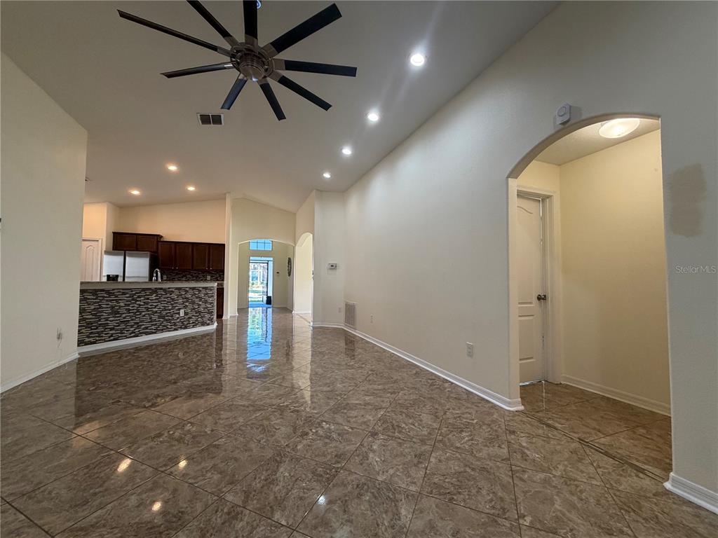 10214 Summer Azure Drive Riverview, FL 33578 - Photo 5 of 23 an empty room with wooden floor and a ceiling fan