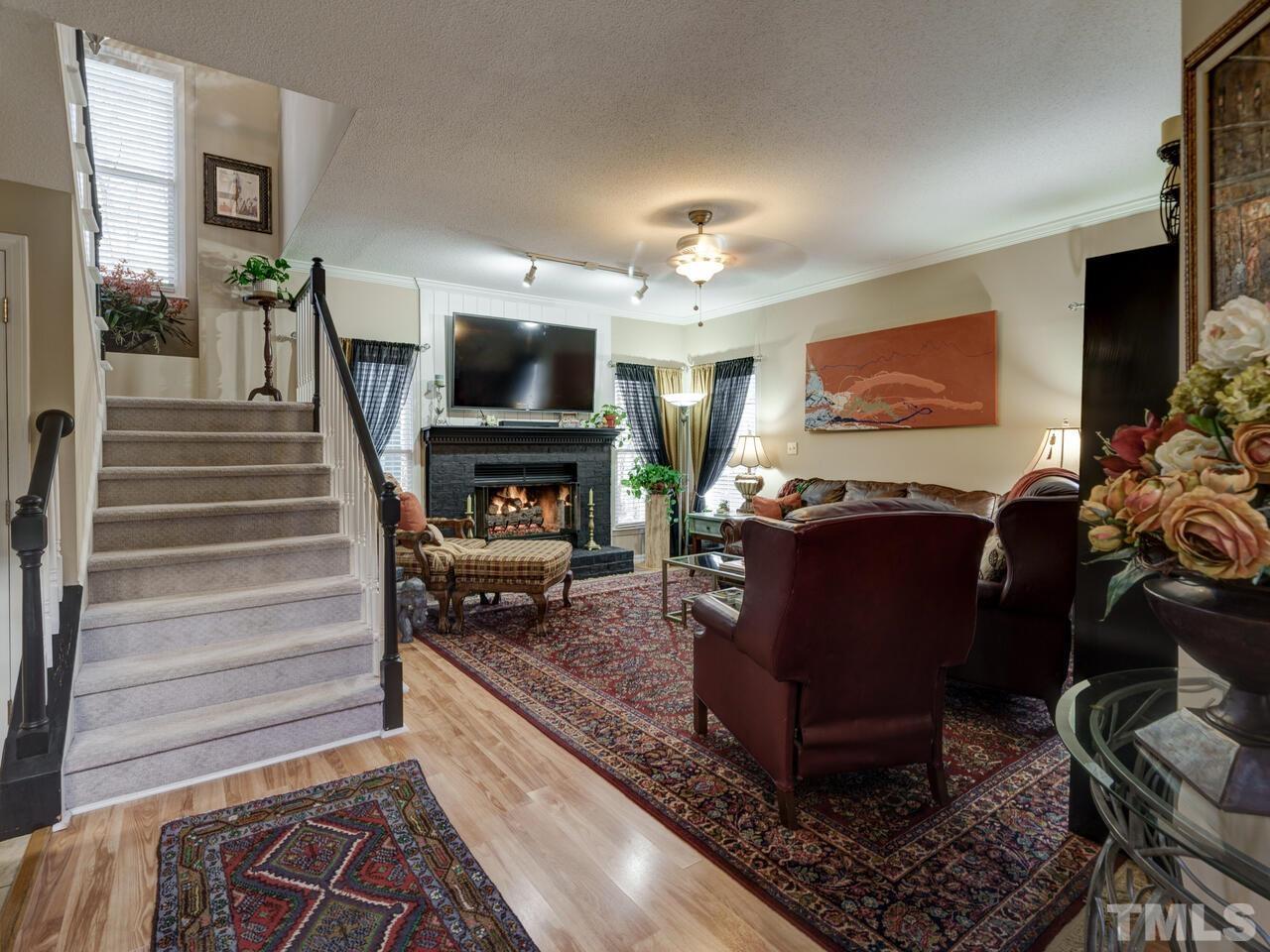 5933 Dunbarton Way Raleigh, NC 27613 - Photo 26 of 48 a living room with furniture and a fireplace