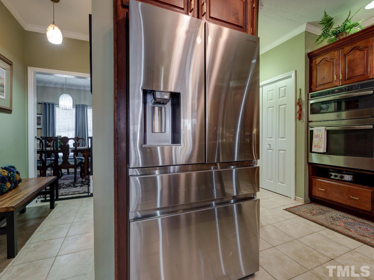 5933 Dunbarton Way Raleigh, NC 27613 - Photo 6 of 48 a kitchen with stainless steel appliances a refrigerator and a stove top oven