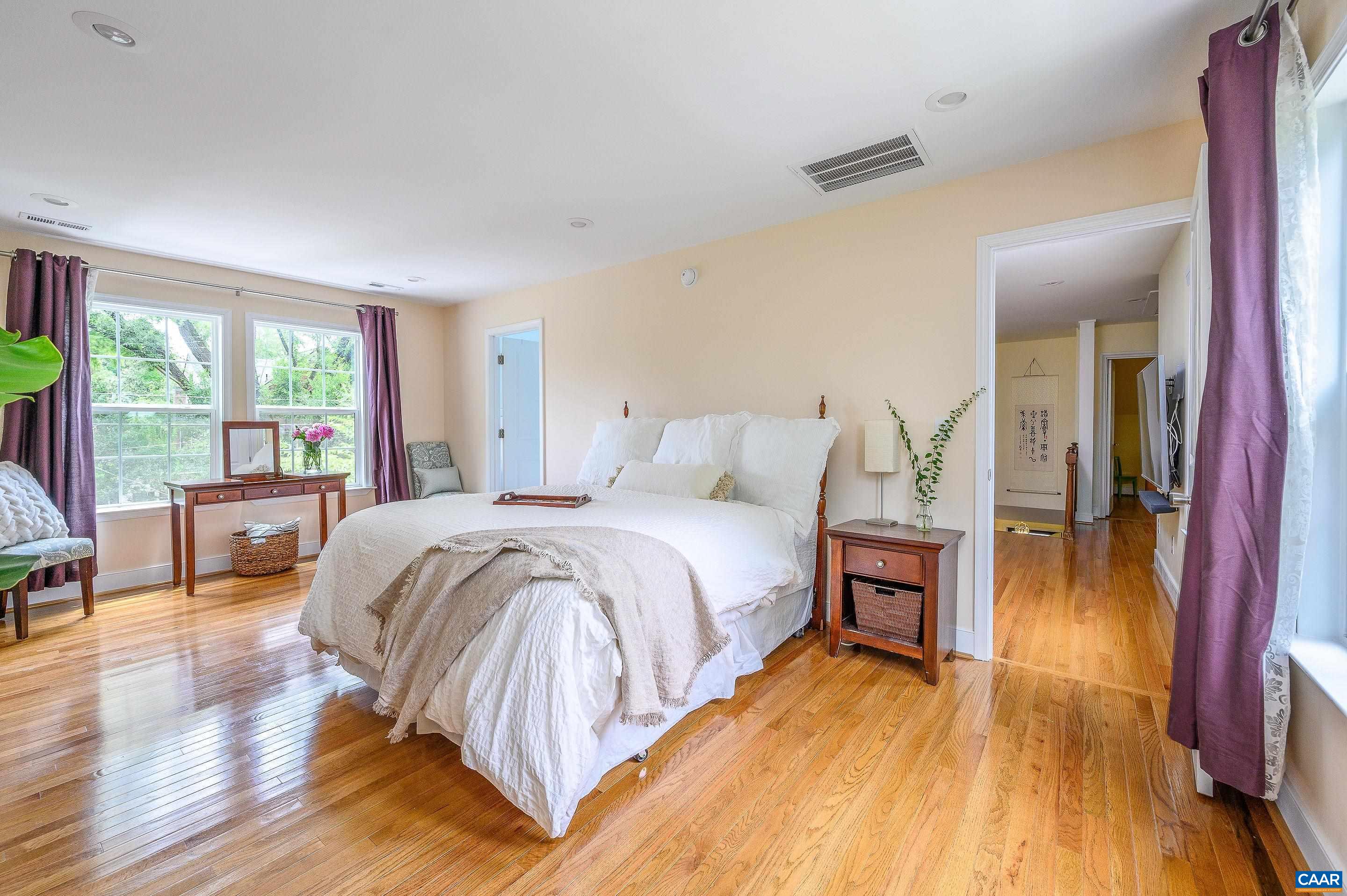 1939 Thomson Road Charlottesville, VA 22903 - Photo 15 of 35 a spacious bedroom with a bed and wooden floor