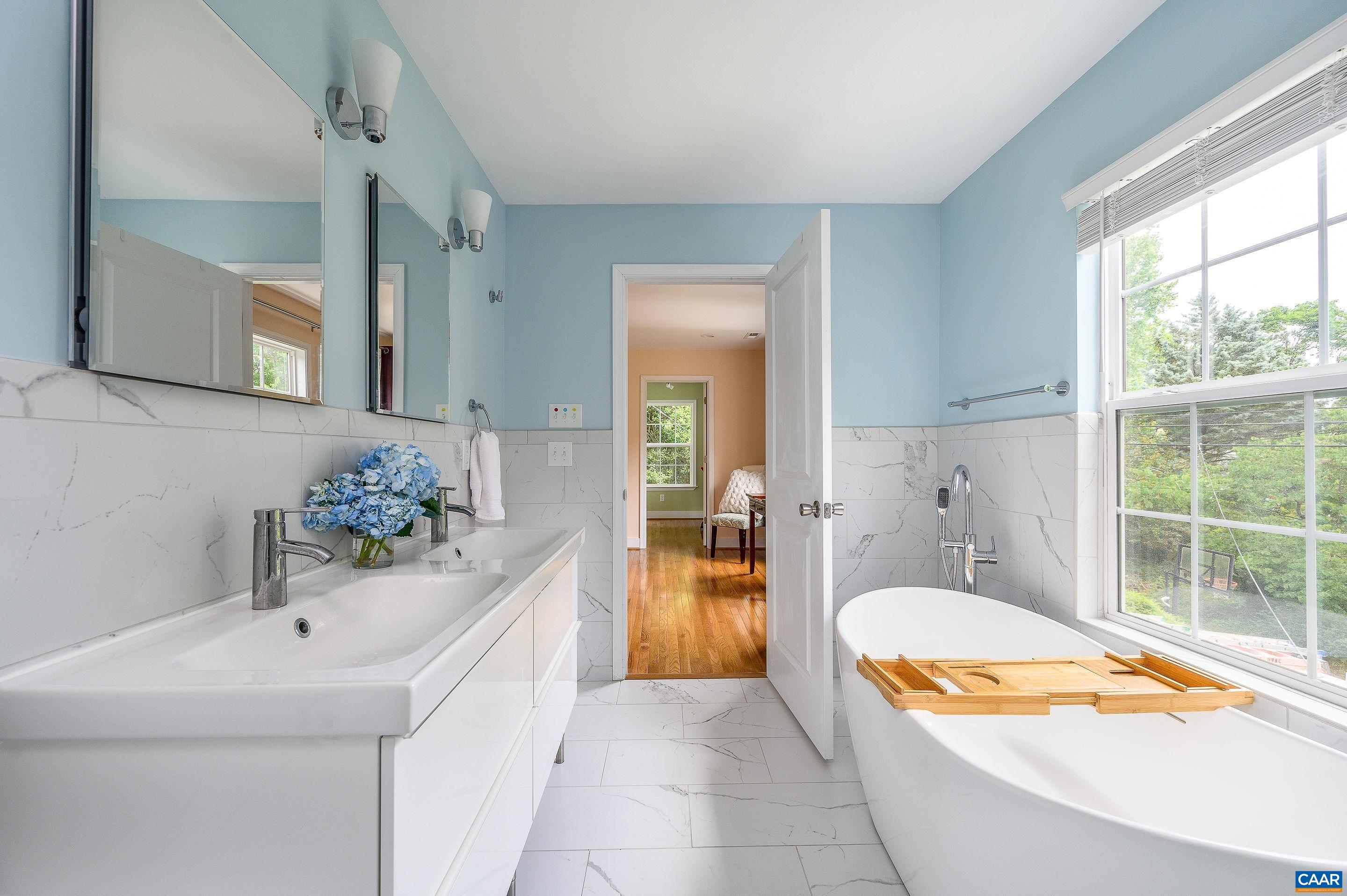 1939 Thomson Road Charlottesville, VA 22903 - Photo 18 of 35 a bathroom with a tub sink and mirror