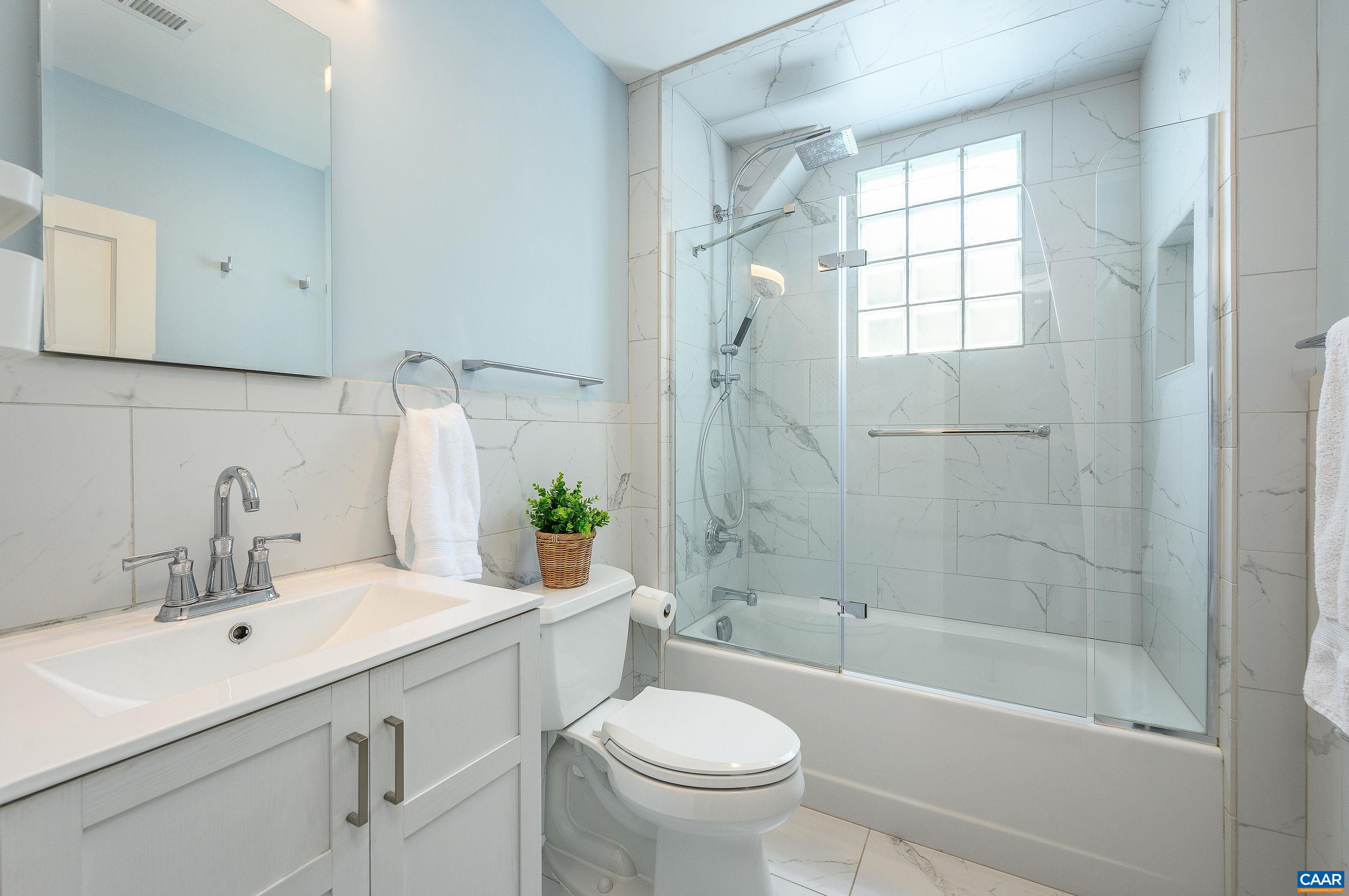 1939 Thomson Road Charlottesville, VA 22903 - Photo 23 of 35 a bathroom with a sink toilet a mirror and shower