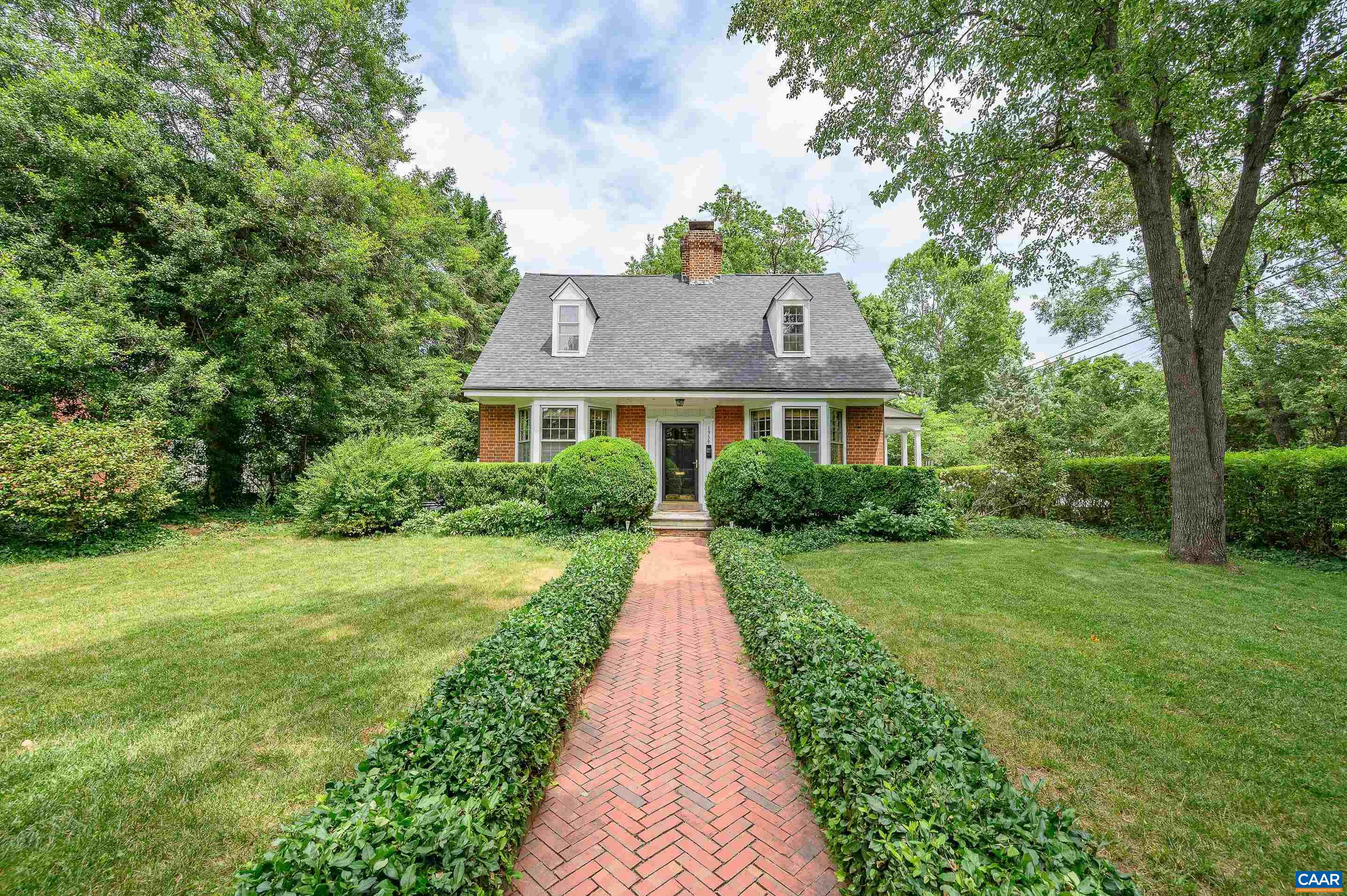 1939 Thomson Road Charlottesville, VA 22903 - Photo 33 of 35 a view of a brick house with a big yard plants and large trees